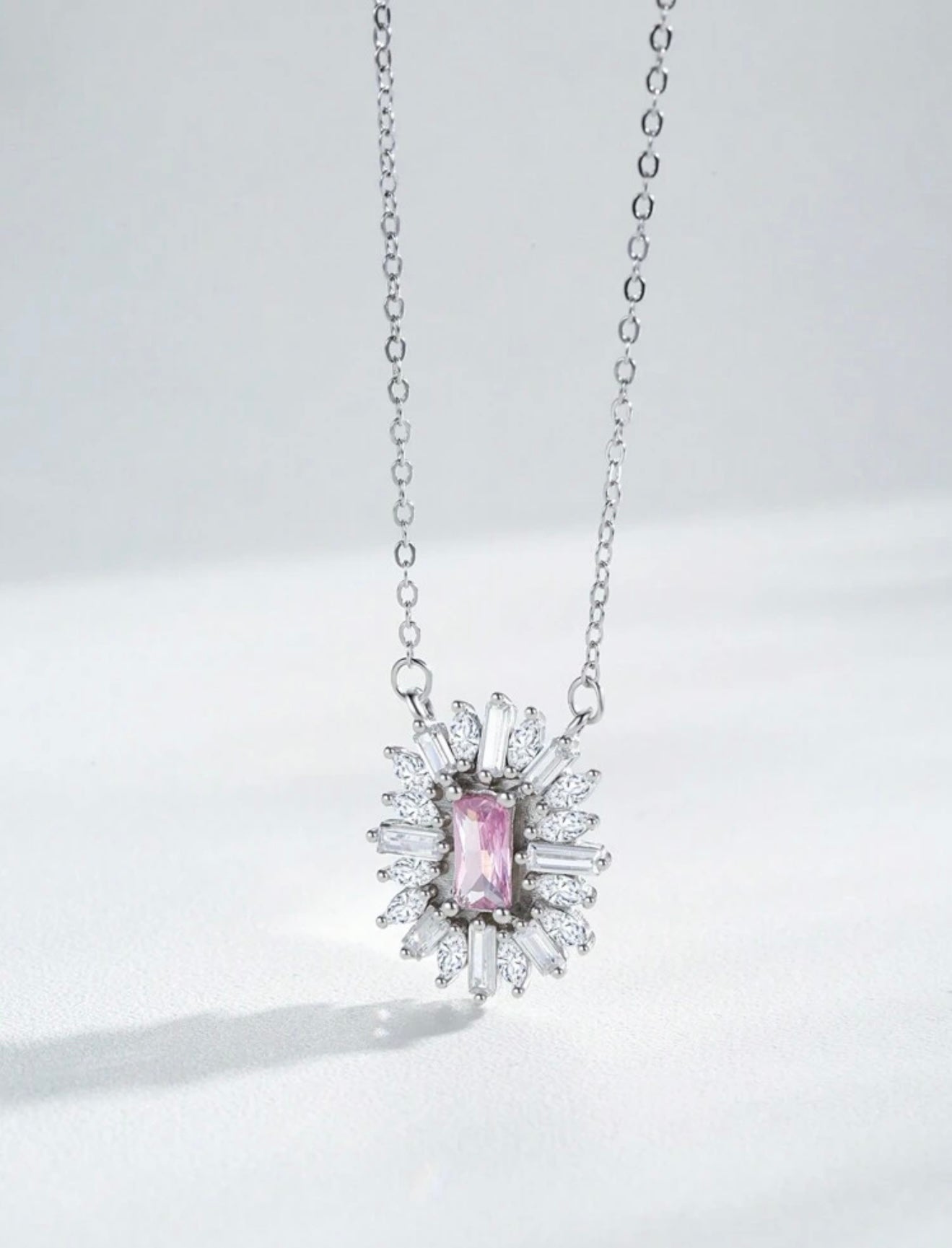 Fashionable luxury 925 sterling silver jewelry with pink sapphire. The set includes a pendant and earrings.
