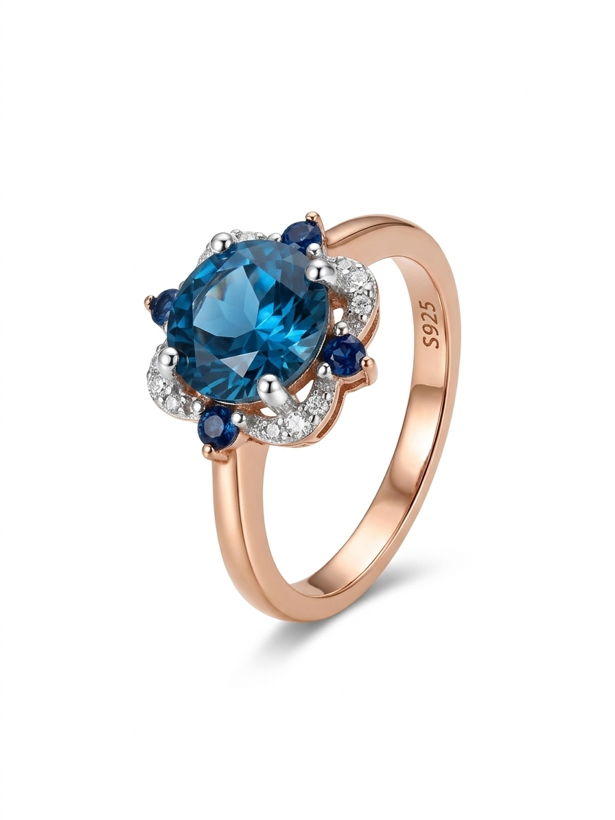 The Marina Bloom gold-plated silver ring is inlaid a round blue lab-grown sapphire
